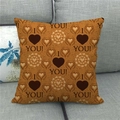 Close-up of linen pillowcase with heart patterns and I Love You text on a sofa - Orange Brown I Love You(8)