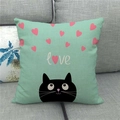 Close-up of linen pillow cover featuring a black cat and pink hearts on a grey sofa - Light Green Heart Cat Style (3)
