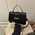 Fashionable black quilted crossbody bag with a gold clasp and top handle for women - Black