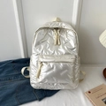 White glossy quilted backpack for women featuring soft padded texture and woven zipper pulls - White