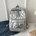 Chic silver quilted backpack with spacious compartments and woven grey zipper pulls - Silver