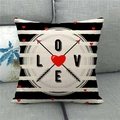 Close-up of linen pillowcase with black stripes and red heart LOVE graphic on a sofa - Heart Letter Arrow Design (7)