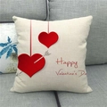 Close-up of linen Valentine's Day pillow case with red hearts on a grey fabric sofa - Cupid's Arrow Red Heart Happy Valentine's Day Style (19)