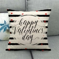 Close-up of Happy Valentine's day linen pillow cover on a grey sofa with heart patterns - Handwritten Holiday Script (12)