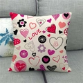Detail of linen pillowcase with LOVE heart floral pattern on a gray fabric sofa - Pink Heart Love Style (8)