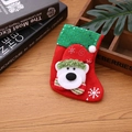 Detail of red Christmas stocking with 3D polar bear and green sequin cuff on wood - Sequin Bear / Small
