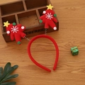Detail view of red Christmas tree headband with spring-loaded stars on wooden background - Small Tree Style / Red