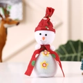 Detail of Christmas snowman ornament featuring red polka dot hat and golden mini bell - Red