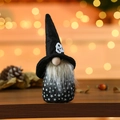 Detail of Halloween gnome with skull hat and star pattern on warm bokeh background - Black