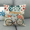 Detail of linen pillowcase with retro bicycle and hot air balloon on a grey sofa - Vintage Hot Air Balloon And Bicycle Illustration Style (5)