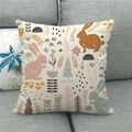 Close-up of Easter linen pillowcase with bunny and forest pattern on a grey sofa - Pink Orange Green Rabbit Plant Style (15)
