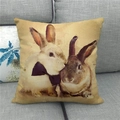 Detail of vintage linen pillowcase featuring artistic Easter rabbits on a grey sofa - Vintage Pearl Necklace Rabbit Style (10)