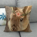 Close-up of linen pillowcase with bunny and flower crown on a grey fabric sofa - Floral Wreath Rabbit Wood Grain (11)