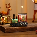 Detail shot of a light-up Christmas train with Santa Claus and warm LED light - Red Santa Style