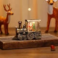 Close-up of vintage lighted Christmas train ornament featuring Santa and warm LED glow - Brushed Gold Santa