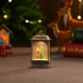 Detalle de linterna navideña con Papá Noel, luz LED y efecto de purpurina flotante - Farol plano vintage cepillado en oro (Niño) / Con agua