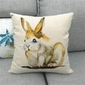 Detail of linen pillowcase with watercolor Easter bunny print on a grey sofa - 45x45cm / Artistic Watercolor Style Rabbit