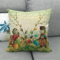 Close-up of Easter linen pillowcase with cats and eggs on a gray sofa - 45x45cm