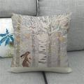 Linen Easter pillow cover with bunny and forest pattern on a grey fabric sofa - 45x45cm