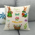 Detail of Easter linen pillowcase with bunny and egg print on grey fabric sofa - 45x45cm