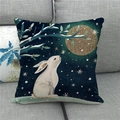 Detail of Easter pillow cover with white rabbit and golden moon on a gray sofa - 45x45cm
