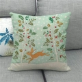Linen Easter cushion cover with bunny and tree illustration on a gray sofa - 45x45cm