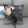 Detail of linen cushion cover with black bunny and moon print on a grey sofa - 45x45cm