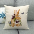 Detailed close-up of a linen Easter pillow cover with rabbit and floral print on gray sofa - Rabbit with Neck Flowers (8)