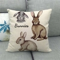 Linen Easter pillow cover with bunnies illustration on a gray fabric sofa - Three Bunnies Illustration (9)
