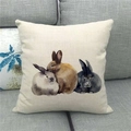 Detail of linen pillowcase featuring three artistic watercolor rabbits on a sofa - Realistic Three Rabbits (12)
