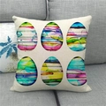 Close-up of Easter linen pillowcase with watercolor egg patterns on a gray sofa - 18x18 Inch / Six Striped Watercolor Eggs (7)
