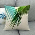 Linen cushion cover featuring green palm leaf print on a minimalist grey fabric sofa - Pattern 11 (11) / 18x18 Inch