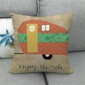 Detail of linen pillowcase with retro camper graphics and enjoy the ride text on sofa - Orange Green Camper Enjoy the ride (12)