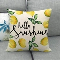 Linen pillowcase with lemon design and Hello Sunshine print on a grey sofa - Lemon Hello Sunshine (14)