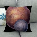 Detail of linen pillow cover featuring red and purple planets on a gray fabric sofa - Twin Planets Pattern (9)