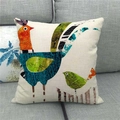 Close-up of linen pillowcase with artistic bird prints on a modern gray fabric sofa - Artistic Collage Style Two Birds (7)