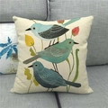 Detail of square linen pillowcase with cute blue bird and floral prints on a gray sofa - Three Blue Artistic Birds (8)