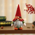 Close-up of a handmade Christmas gnome doll with a red knit hat and pine cone details - Boy Style with Long Beard / Red Hat