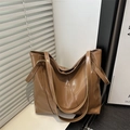 Brown minimalist tote bag in glossy faux leather with decorative stitching for daily commute - Brown