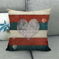 Detailed close-up of a vintage American flag heart pillow case on a grey fabric sofa - 18x18 Inch / Nostalgic Crackle Heart (11)