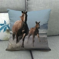 Linen cushion cover featuring wild horses running on African savannah, placed on a sofa - Horses By Water Style (9) / 45x45cm