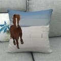 Close-up of linen pillow cover showing running horse print on a grey fabric sofa - Snow Galloping Style (11) / 45x45cm
