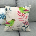 Close-up of bird and flower watercolor patterns on a natural linen cushion cover - Green Bird Red Beak With Pink Blue Leaves (10)