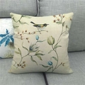 Detailed texture of linen pillowcase with floral bird print on a grey fabric sofa - Colorful Kingfisher Magnolia (14)