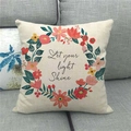 Christmas linen pillowcase with Let Your Light Shine floral wreath on grey sofa - Floral Ring Lettering (5)