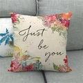 Detailed texture of Home Sweet Christmas wreath linen pillowcase on a grey sofa - Watercolor Color Block Floral (7)