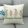 Close-up of Happy Easter linen pillowcase with gnome illustration on a gray sofa - Standard Square
