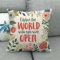 Detail of linen pillowcase with floral wreath and Explore the World quote on sofa - Colorful Floral Quote (16)