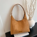 Retro camel suede shoulder bag with leather strap and logo tag on a minimalist background - Brown No Pendant
