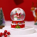 Detail of Christmas snow globe featuring Santa and snowman on a red festive base - Style 2 / Medium With Light